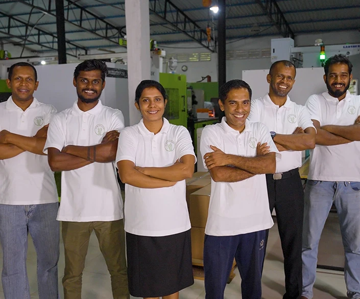 A team of workers positioned in a factory, showcasing a collaborative environment with industrial elements in the background
